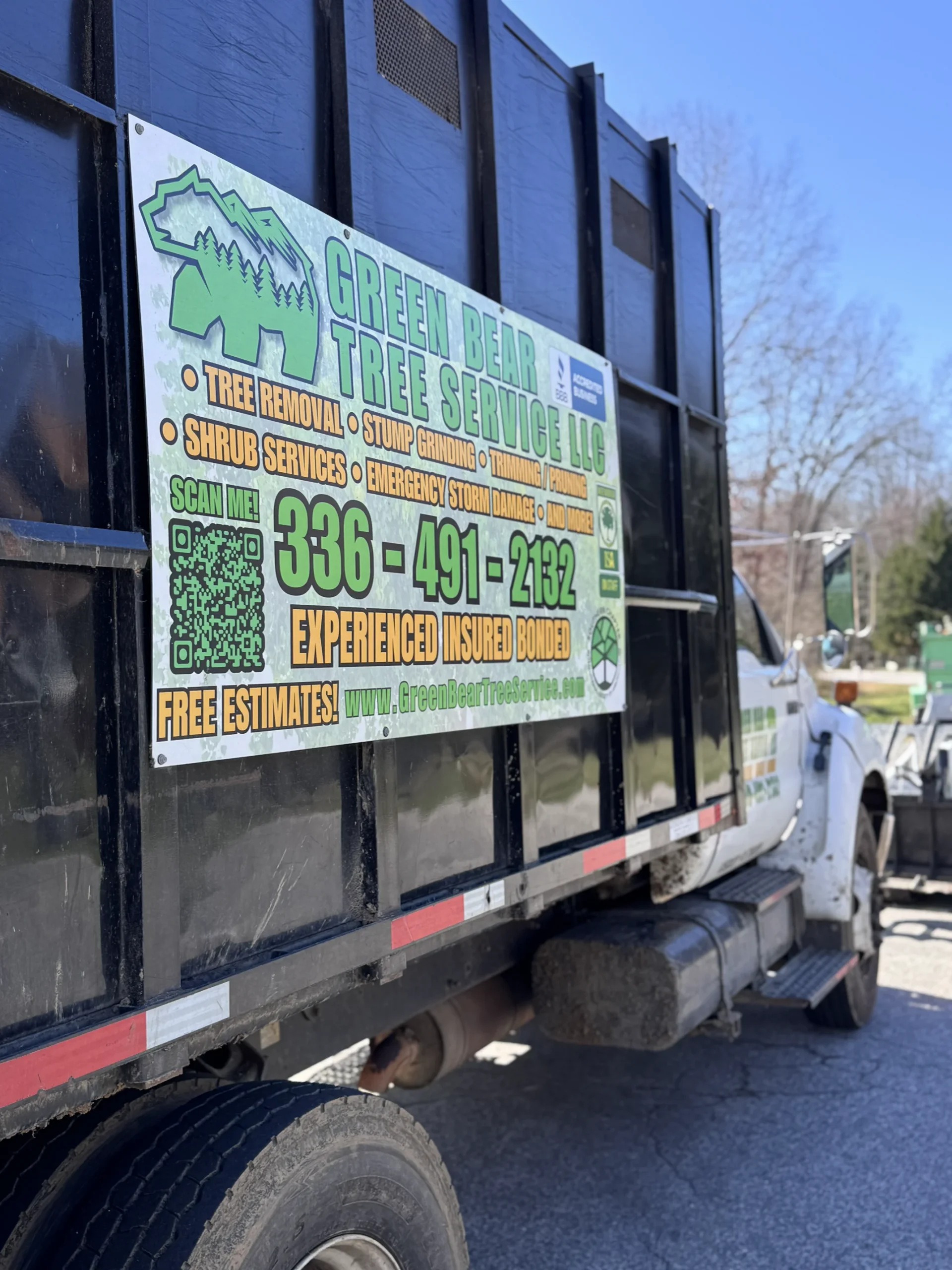 Green Bear Tree Service work truck and equipment signage